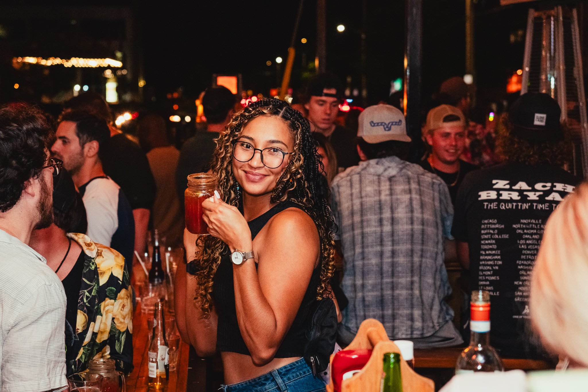 Girl smiling with a cocktail in her hand